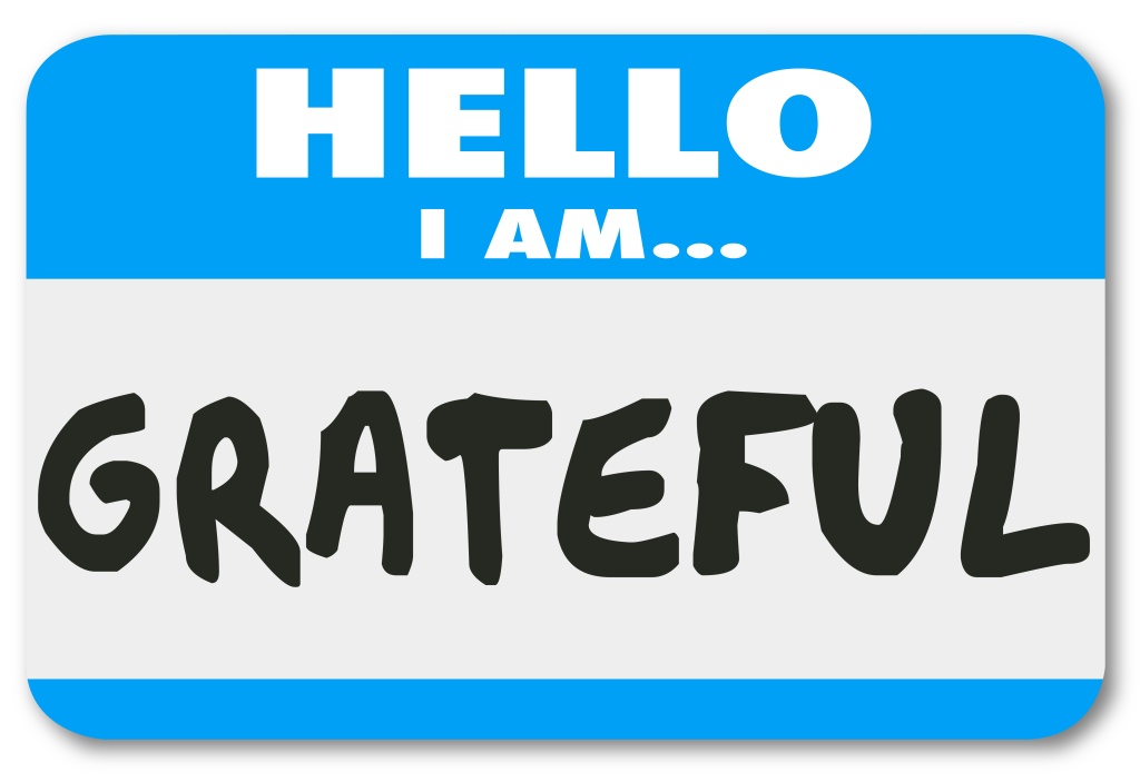 Hello I Am Grateful words on a name tag sticker telling others you are thankful and appreciative for the valuable things in your life such as health, friends and family
